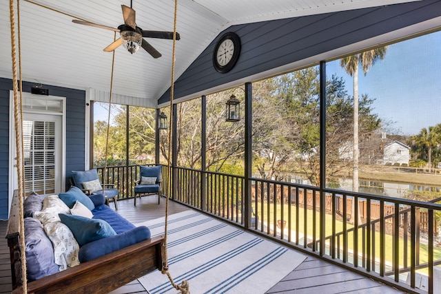 sunroom with lofted ceiling and ceiling fan