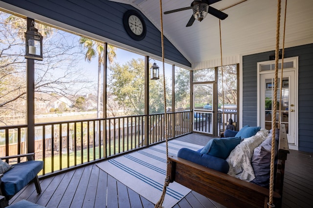 sunroom / solarium featuring lofted ceiling and ceiling fan