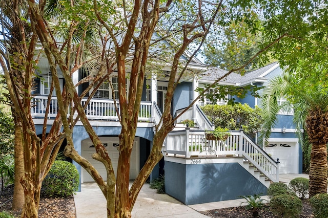 exterior space featuring a garage, central AC unit, and stairway