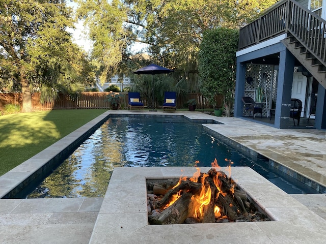 view of swimming pool with a fenced backyard, stairs, a yard, a fenced in pool, and a patio area