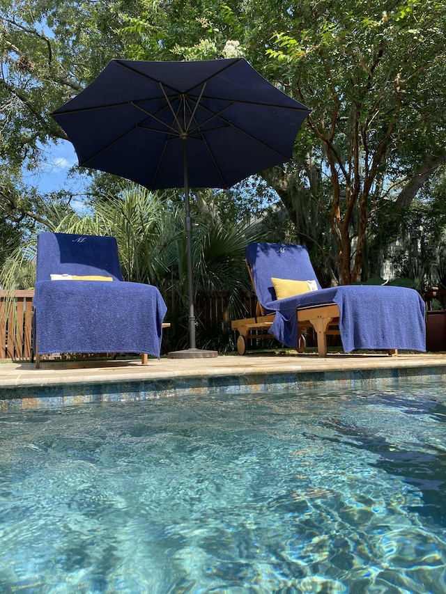 outdoor pool featuring fence