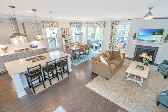 2234 Mother Of Pearl Dr, Mount Pleasant, SC 29466 - living room featuring dark wood-style floors, a chandelier, crown molding, a fireplace with flush hearth, and recessed lighting