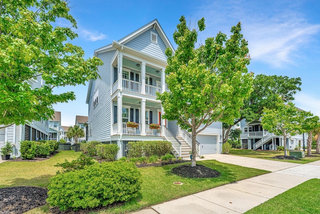 2234 Mother Of Pearl Dr, Mount Pleasant, SC 29466 - view of front of house with a porch, a balcony, a garage, and a front yard
