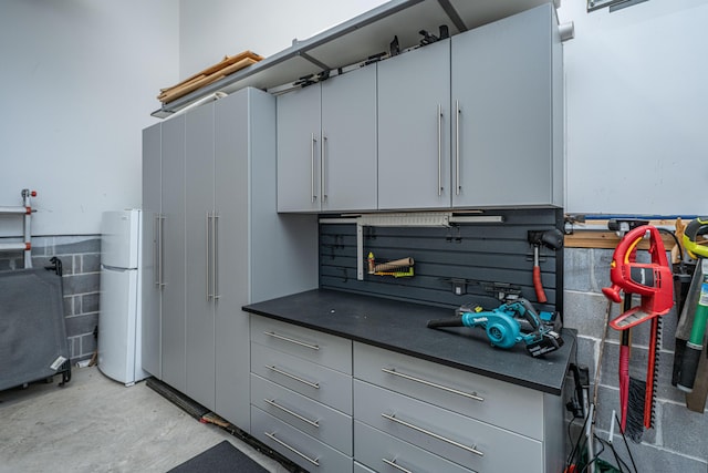2234 Mother Of Pearl Dr, Mount Pleasant, SC 29466 - kitchen with freestanding refrigerator, concrete floors, and dark countertops