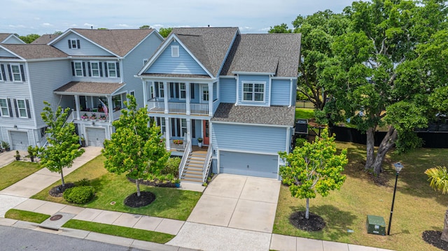 2234 Mother Of Pearl Dr, Mount Pleasant, SC 29466 - view of front of home with a garage, concrete driveway, a shingled roof, a front lawn, and stairway