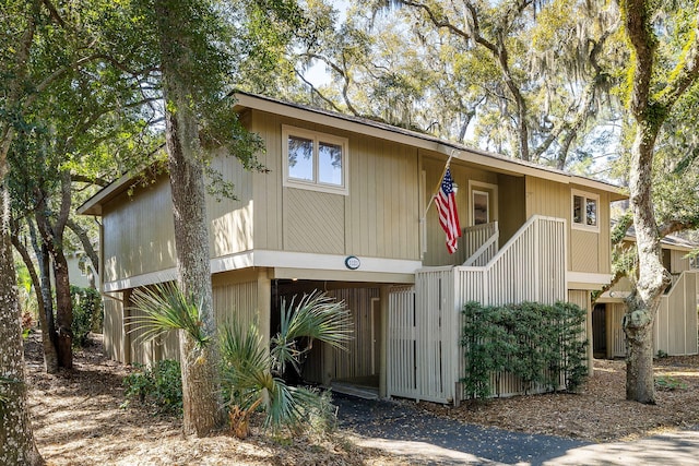 view of front of house featuring driveway and stairs
