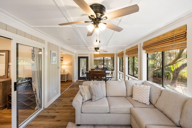 sunroom / solarium featuring a ceiling fan