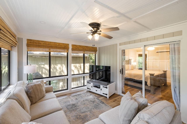 sunroom featuring a ceiling fan