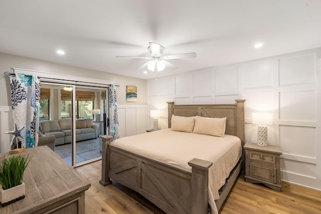bedroom with recessed lighting, light wood-style flooring, a decorative wall, a ceiling fan, and access to outside