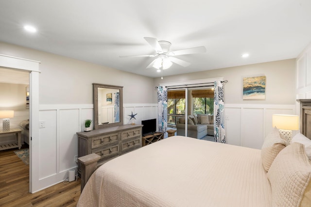 bedroom with wainscoting, recessed lighting, wood finished floors, a decorative wall, and a ceiling fan