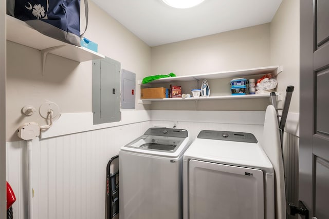 laundry room featuring electric panel, laundry area, and washer and clothes dryer