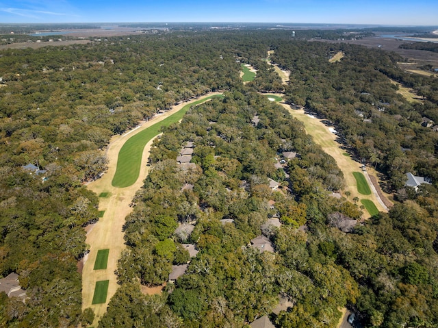 bird's eye view featuring golf course view and a view of trees