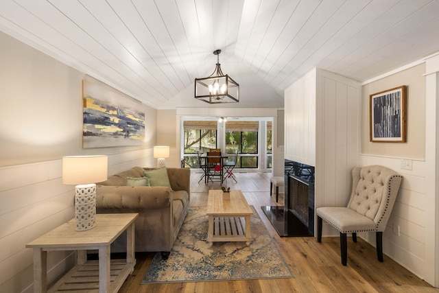 living room featuring a chandelier, wooden ceiling, wood finished floors, and vaulted ceiling