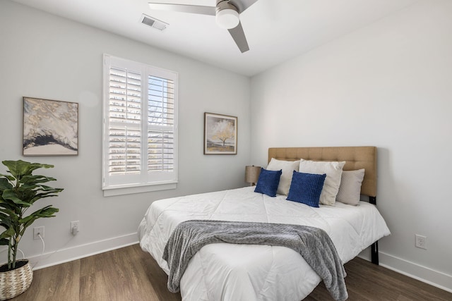 bedroom featuring visible vents, baseboards, and wood finished floors