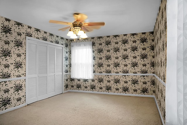 unfurnished bedroom featuring carpet and wallpapered walls