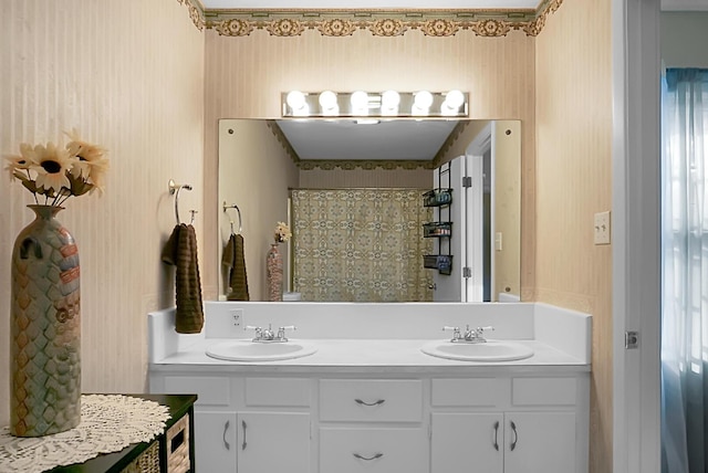 full bathroom featuring a sink, a shower with curtain, wallpapered walls, and double vanity