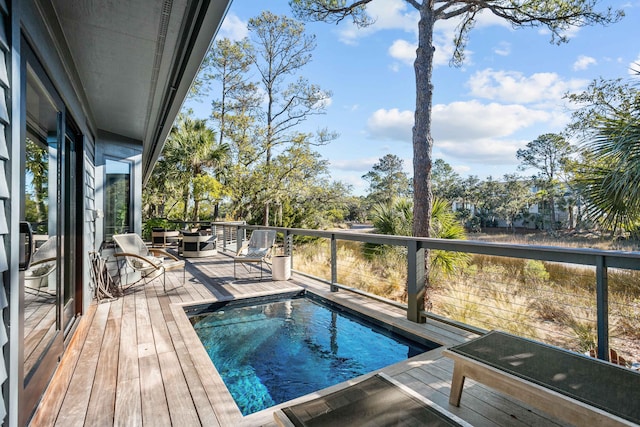 view of pool featuring an outdoor fire pit