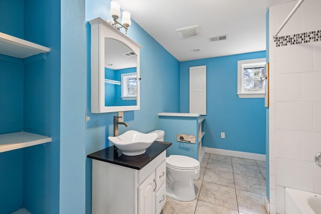 bathroom featuring visible vents, a healthy amount of sunlight, and vanity