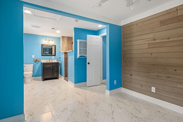 unfurnished bedroom featuring visible vents, marble finish floor, baseboards, and a sink