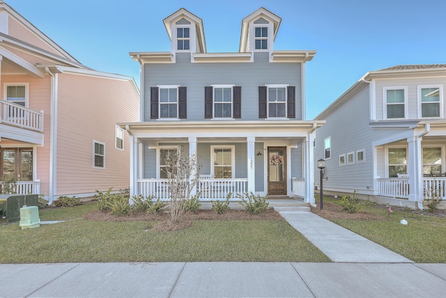 view of front facade featuring a porch, a front lawn, and cooling unit