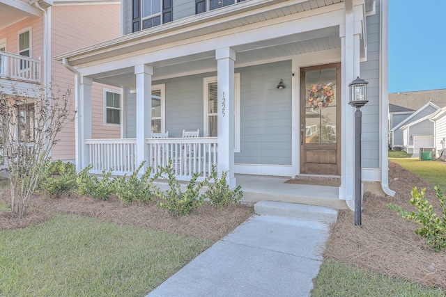 view of exterior entry with covered porch