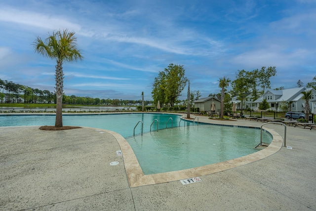 community pool with a patio and fence