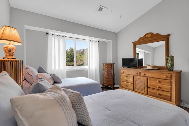 bedroom featuring visible vents and vaulted ceiling