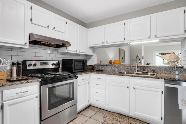 kitchen with range hood, stainless steel appliances, decorative backsplash, white cabinets, and a sink