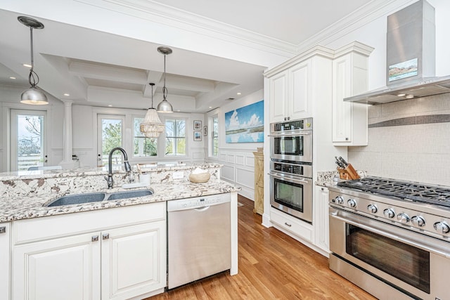 1543 Wando Landing St, Charleston, SC 29492 - kitchen with wall chimney exhaust hood, appliances with stainless steel finishes, a sink, crown molding, and ornate columns