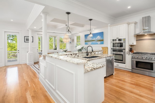 1543 Wando Landing St, Charleston, SC 29492 - kitchen featuring wall chimney exhaust hood, a sink, stainless steel appliances, a center island with sink, and light wood-style flooring