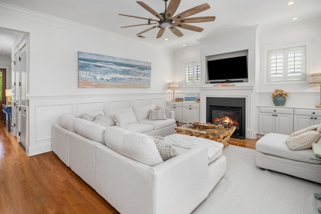 1543 Wando Landing St, Charleston, SC 29492 - living room featuring light wood-type flooring, ceiling fan, ornamental molding, recessed lighting, and a glass covered fireplace