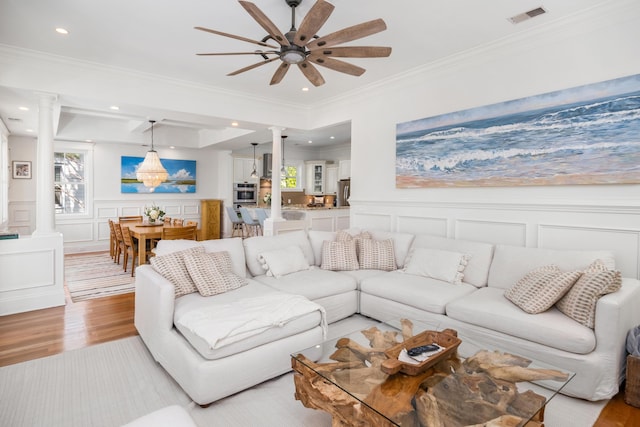 1543 Wando Landing St, Charleston, SC 29492 - living area with decorative columns, a decorative wall, ceiling fan, light wood finished floors, and ornamental molding