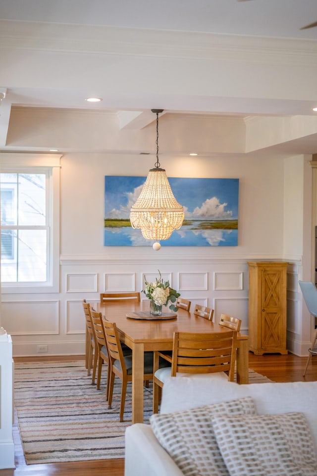 1543 Wando Landing St, Charleston, SC 29492 - dining room with a decorative wall, wood finished floors, a chandelier, ornamental molding, and a wainscoted wall