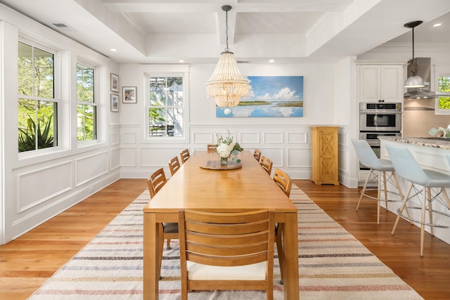 1543 Wando Landing St, Charleston, SC 29492 - dining area featuring a chandelier, a decorative wall, light wood finished floors, and ornamental molding