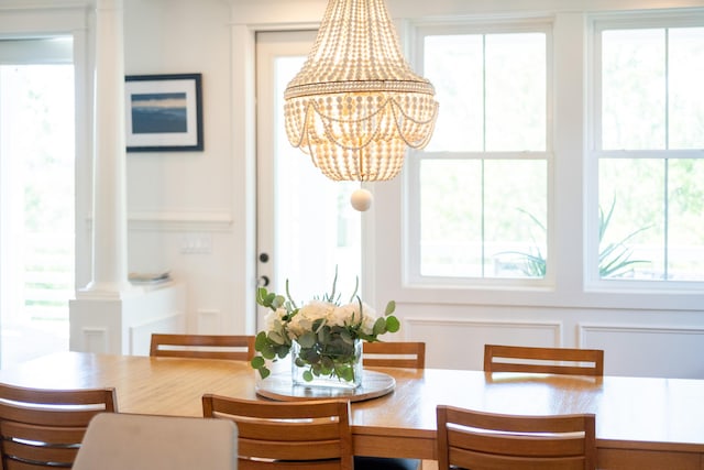 1543 Wando Landing St, Charleston, SC 29492 - dining area with a chandelier, decorative columns, and plenty of natural light