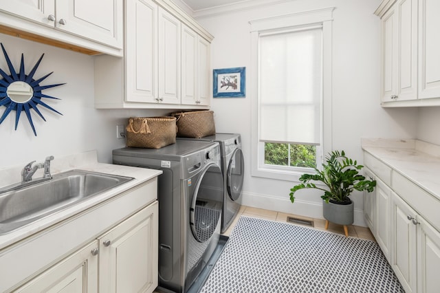 1543 Wando Landing St, Charleston, SC 29492 - washroom featuring cabinet space, separate washer and dryer, light tile patterned flooring, ornamental molding, and baseboards