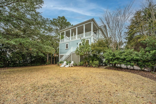 1543 Wando Landing St, Charleston, SC 29492 - back of property with a balcony, stairs, and a yard