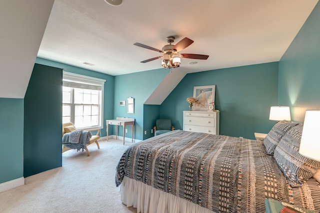 bedroom featuring ceiling fan, light carpet, visible vents, baseboards, and vaulted ceiling