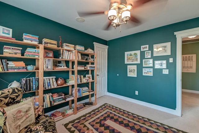 sitting room with carpet, a ceiling fan, and baseboards