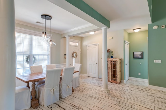 dining room with light wood-style floors, visible vents, ornamental molding, and ornate columns