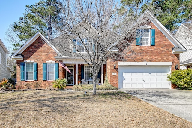 traditional home with a garage, concrete driveway, brick siding, and a porch