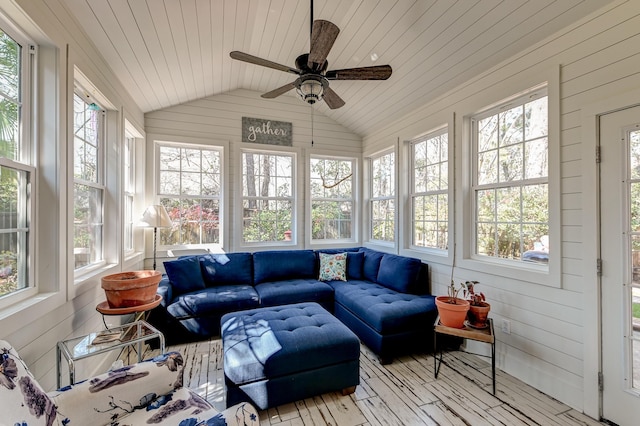 sunroom / solarium featuring lofted ceiling, wooden ceiling, a ceiling fan, and plenty of natural light