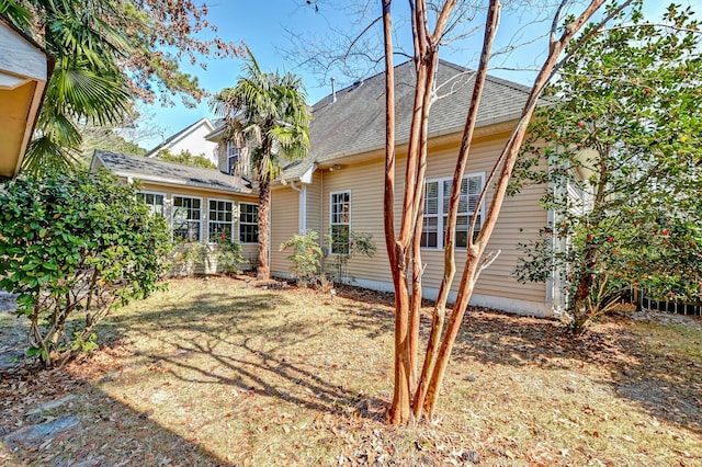 rear view of property featuring roof with shingles