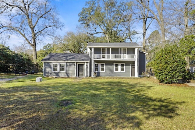 view of front of house with a balcony and a front yard