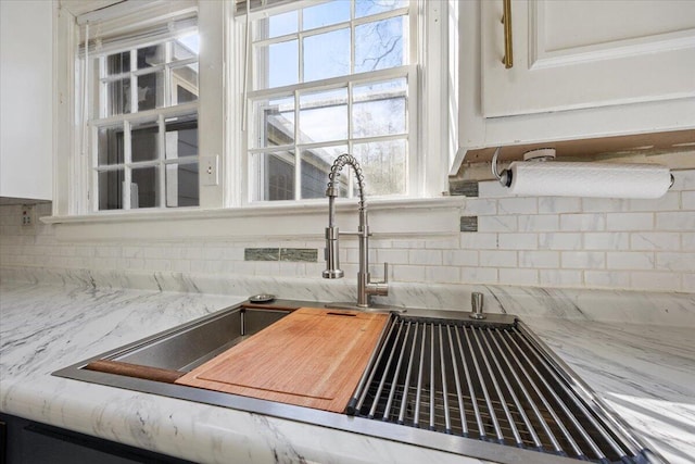 details featuring a sink and backsplash