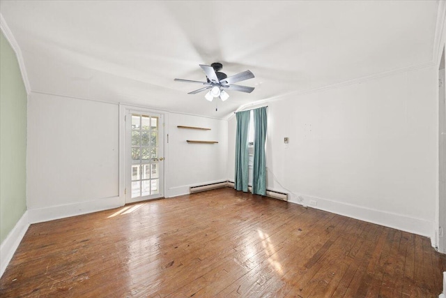 empty room featuring ceiling fan, hardwood / wood-style flooring, baseboards, and vaulted ceiling