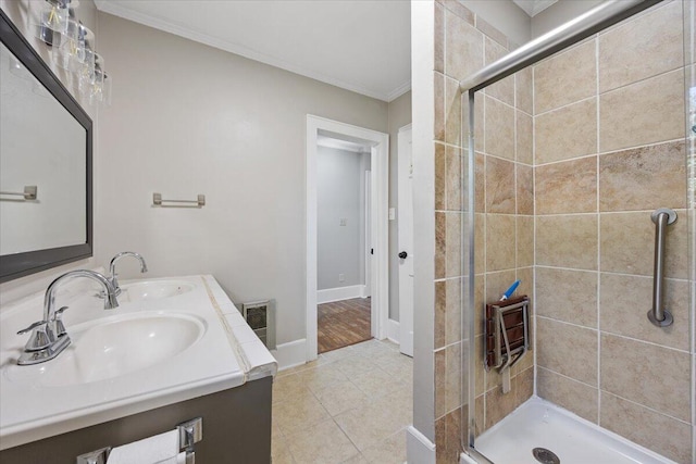 full bathroom with visible vents, ornamental molding, a stall shower, and a sink