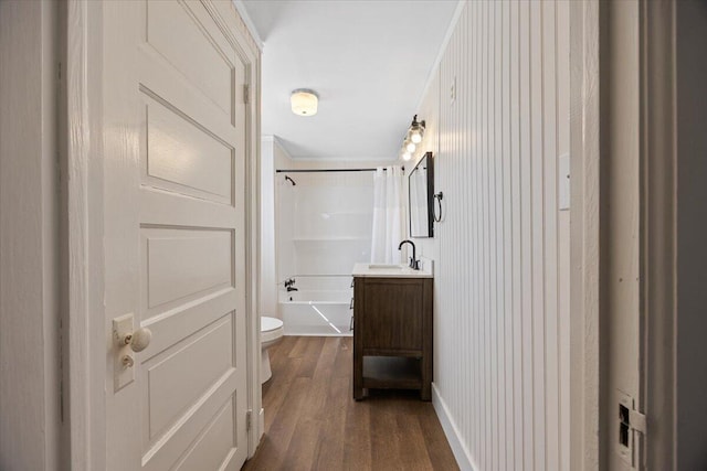 full bath with vanity, toilet, shower / tub combo, and wood finished floors