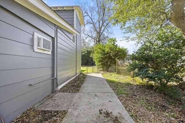 view of yard with a wall mounted AC and fence