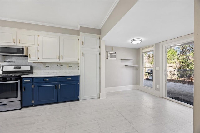 kitchen with white cabinets, blue cabinets, tasteful backsplash, and appliances with stainless steel finishes